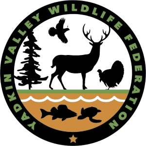 A black and green logo with animals, trees, fish, and deer.