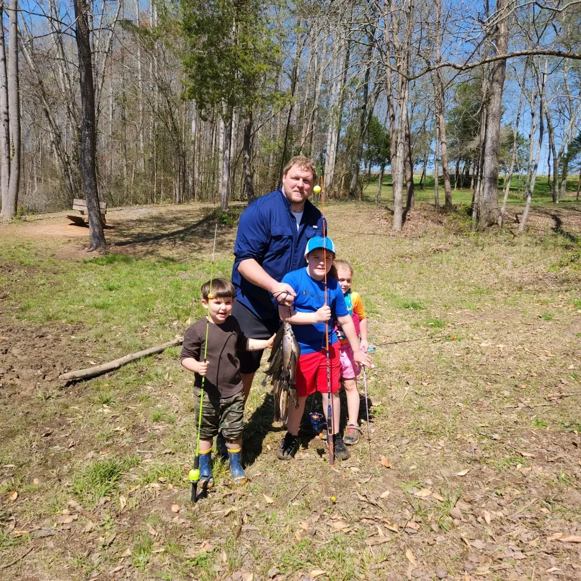 A man and his children in the woods