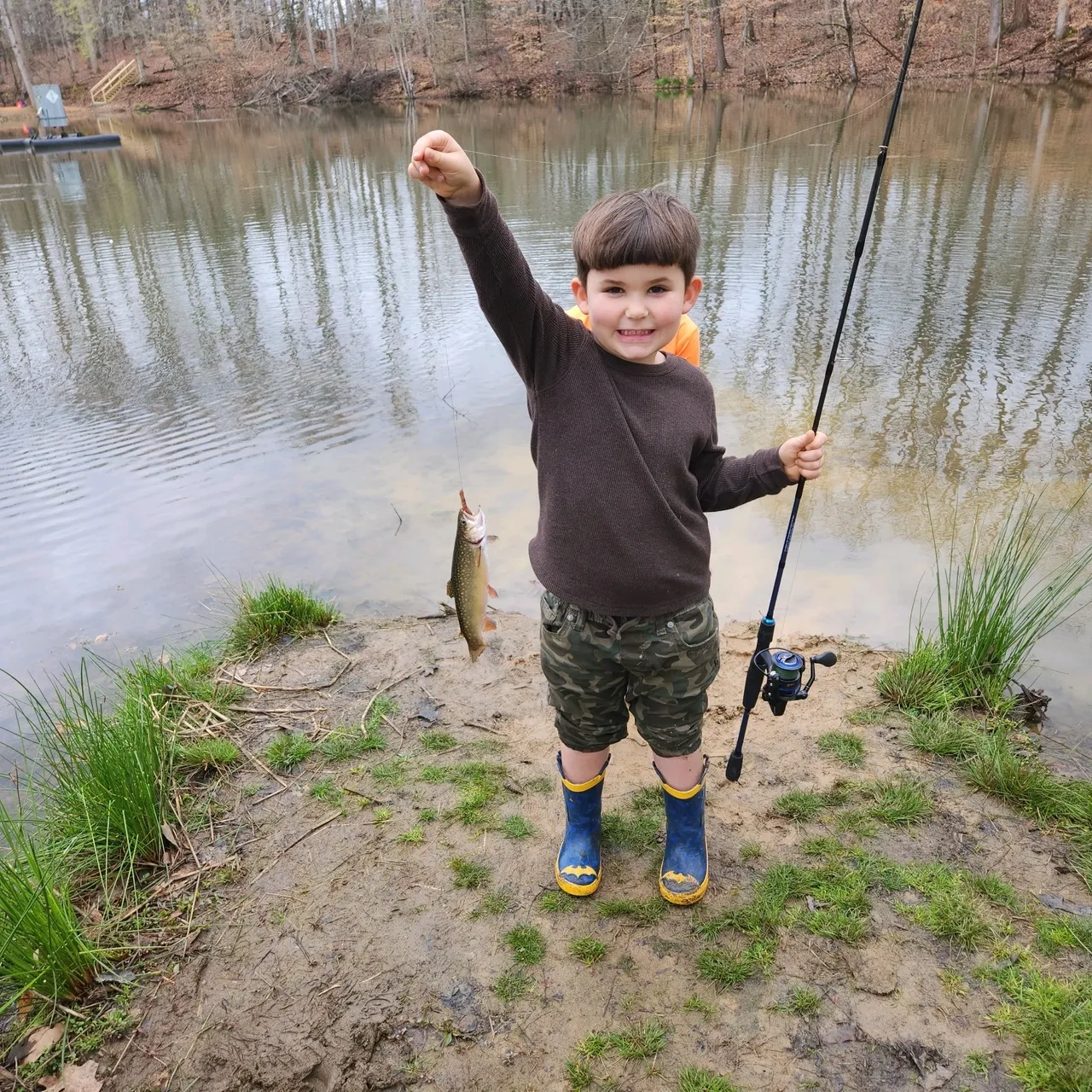 A young boy holding onto a fishing pole